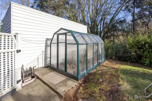 There is a fantastic greenhouse adjacent to the garage.
