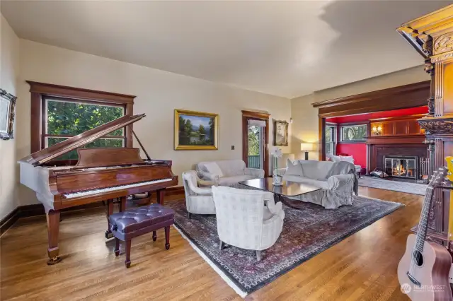 The large formal living room has room for a grand piano.  It flows through large pocket doors into the parlour.