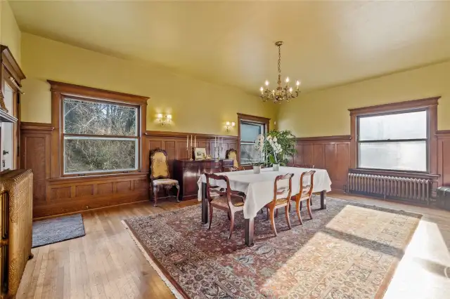 The dining room is bright and sunny with widows facing east and south. Notice the beautiful radiators throughout the home to keep you warm and cozy all winter.
