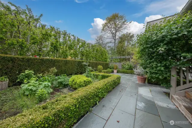 The beautifully appointed gardens are fully fenced and provide serene outlooks with a stone patio and covered deck.
