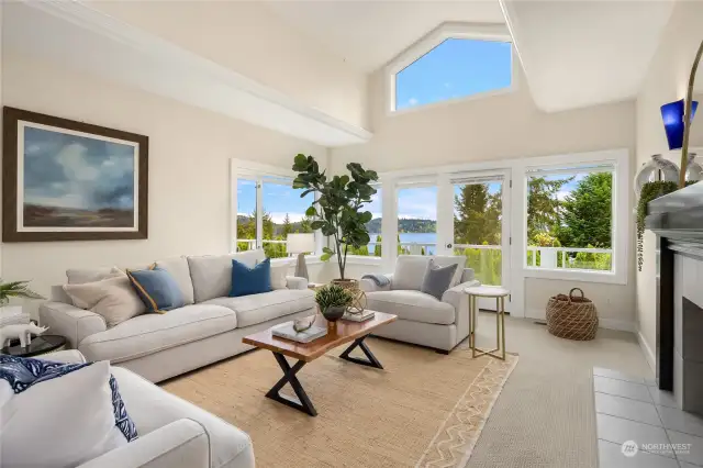 The living room enjoys water views and access to an expansive deck through French doors
