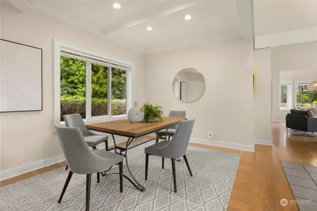 Adjacent dining room with box beam ceiling and garden view