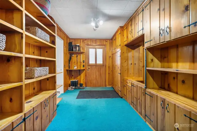 Huge entryway with warm, pine cabinetry and paneling. So much storage!