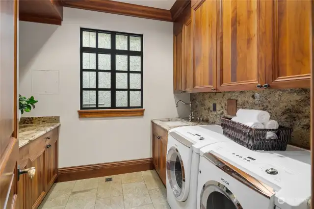 Laundry room with ample storage and counter space.