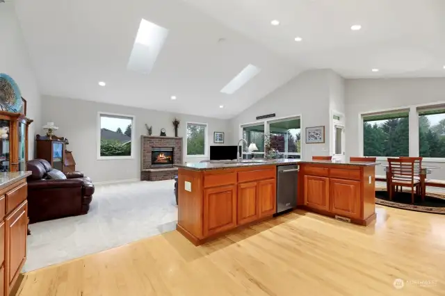 This stunning Kitchen has cherry cabinetry, undercabinet lighting, vaulted ceilings, new skylights, eating bar, eating nook, a door to the covered patio and so much more!