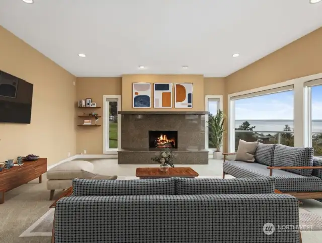Immense granite fireplace anchors very spacious living room.