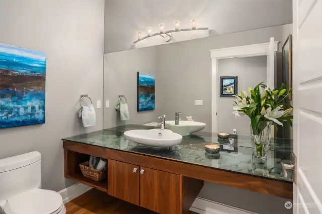 The powder room consists of this custom floating vanity filled with beach rocks. How cool is this!