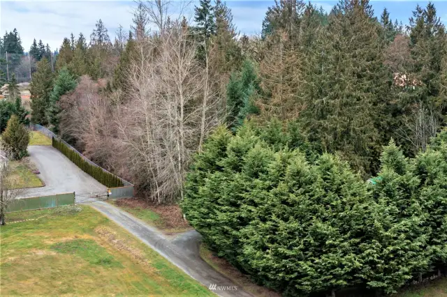 Ariel view showing the corner entrance an neighbors newer fence w/privacy trees