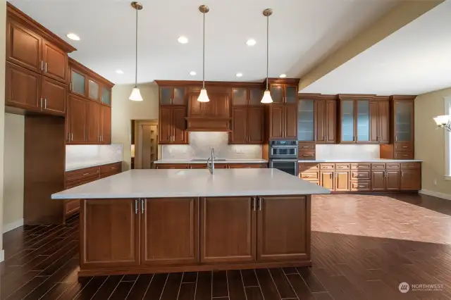 Amazing kitchen with plenty of quality custom cabinets. Drawers are soft-close. Island bar plus an additional eating area.