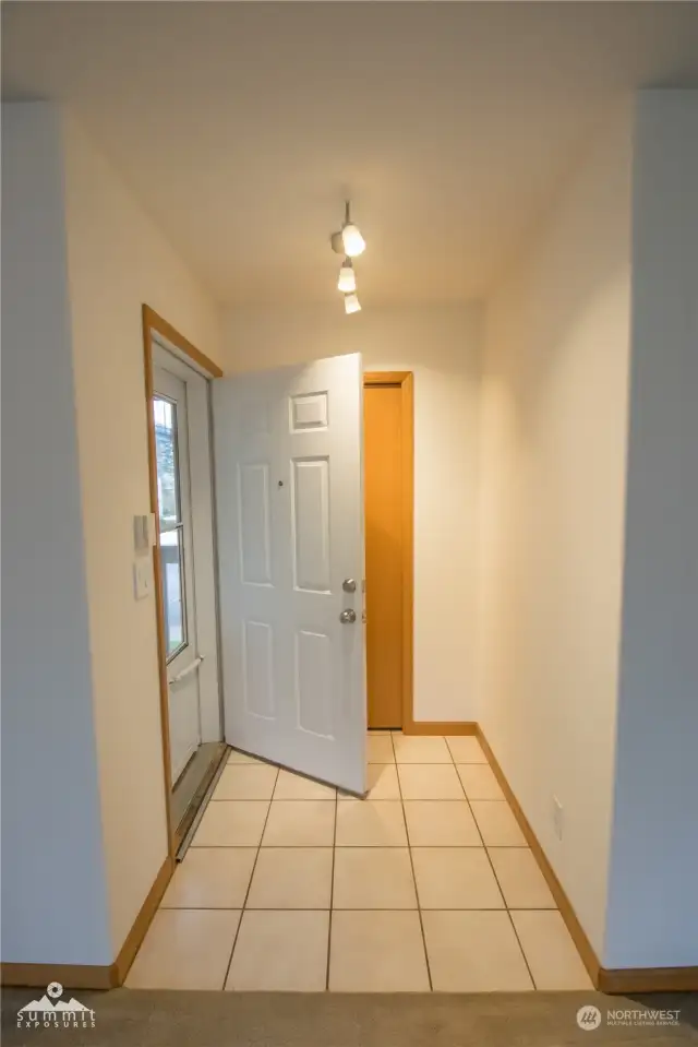 Tiled entrance with coat closet