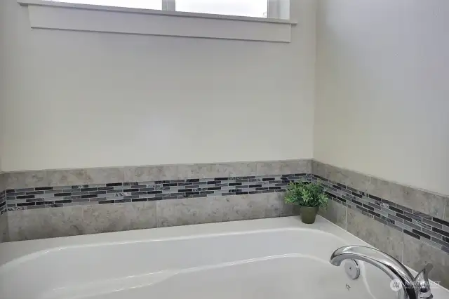 Primary bath has a soaking tub and separate shower.