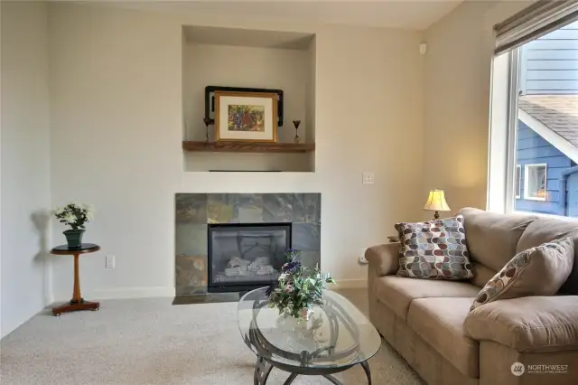 Living room has a gas fireplace and TV wall mount.