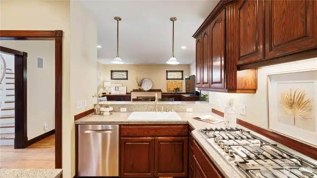 Open kitchen to casual gathering space makes entertaining a breeze.