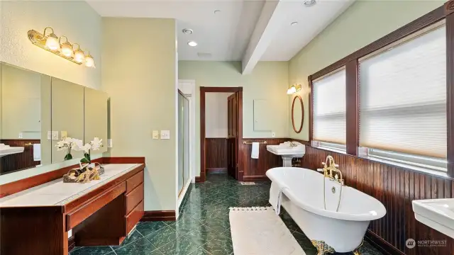 Traditional bath with claw foot soaking tub and separate shower; ample counter space with vanity and great lighting.