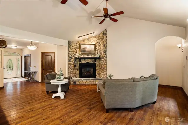 Family Room with River Rock Fireplace. Front Door in background.