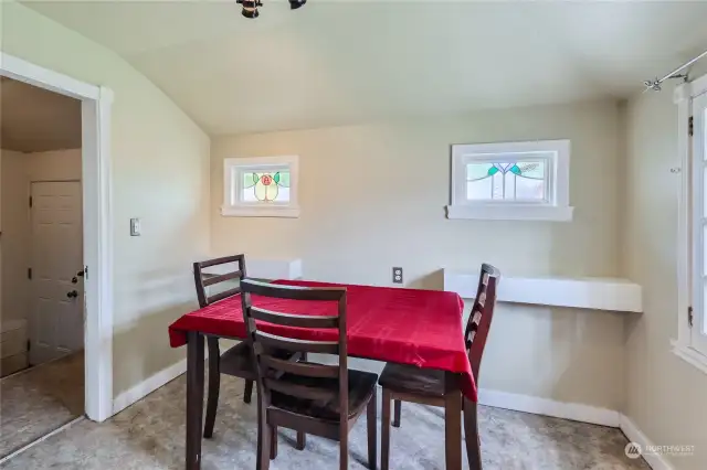 Dining Room with Original Stained Glass Windows. Laundry Room on the Left