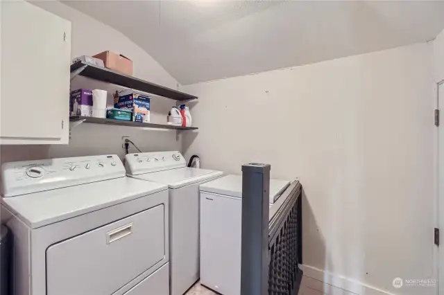 Separate Laundry Room with Washer and Dryer that stay. Rear door a few steps below laundry area.
