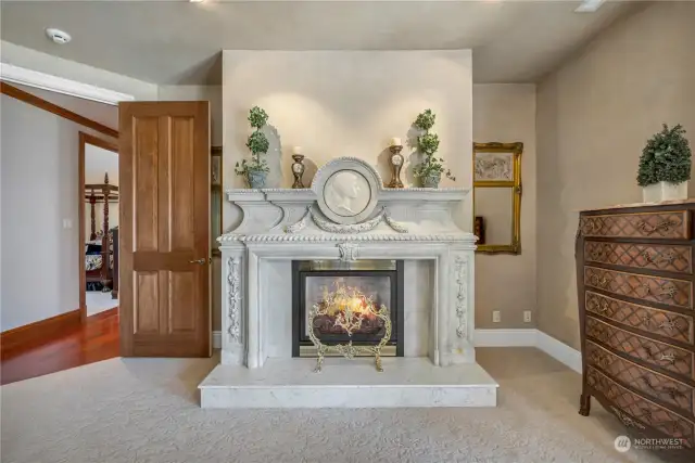 Elegant Carrara Marble surrounds the fireplace and was specially procured from Italy.