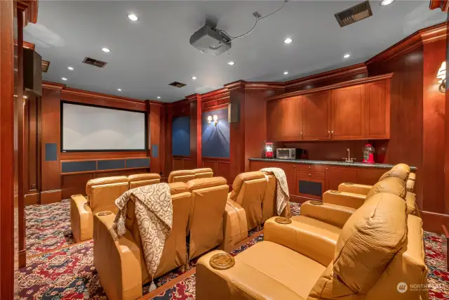 Home theatre! Invite your besties over to watch your favorite films or new releases. Room has lots of custom cabinetry and comfy chairs for 12.