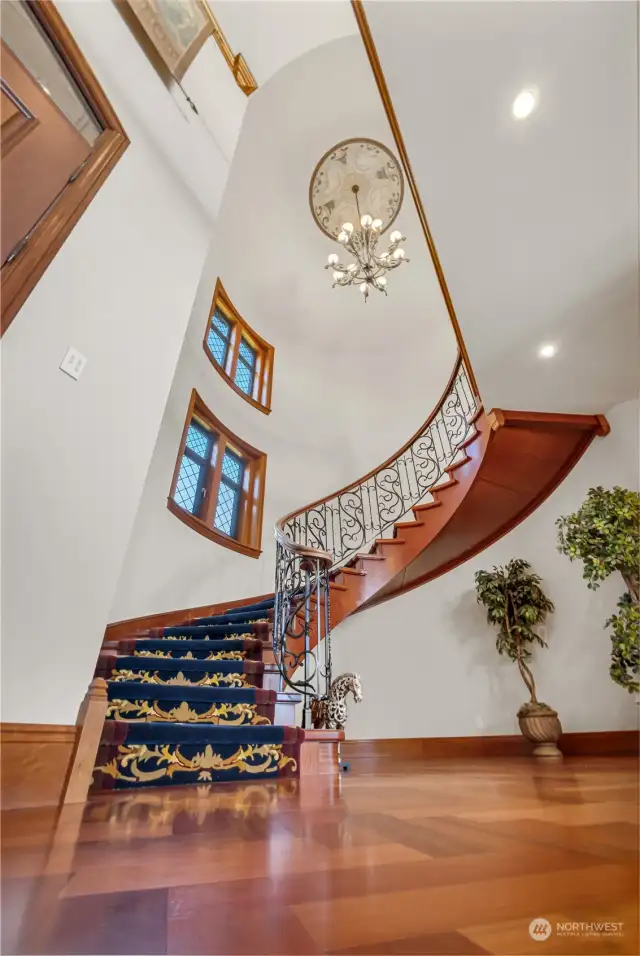 Distinctive Hand painted mural ceiling insert above the chandelier topping the grand spiral stair case