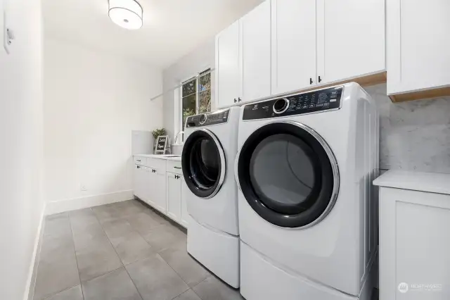 Laundry Room w/ Deep Utility Sink, Washer + Dryer, and Dry Bar for Delicates Drying.