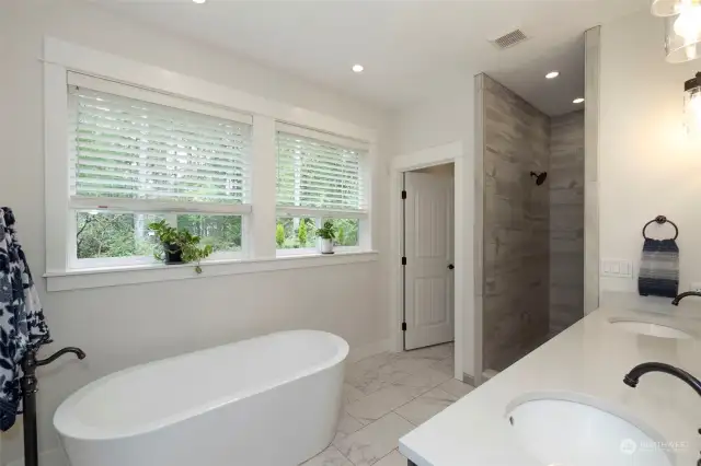 Luxurious 5-piece bath adds a touch of elegance to your incredible primary suite! Heated Tile Floors ~ Dual Sink Quartz top Vanity ~ Tear Drop Bath ~ Walk in, Floor to Ceiling, Custom Tile Shower