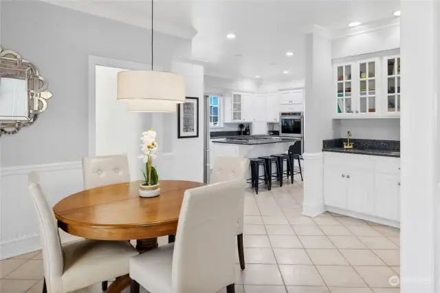 The great room seamlessly flows into the kitchen area through a casual dining space and a convenient butler's bar.