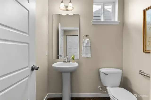 A guest powder room lies between the kitchen and dining room for easy access.