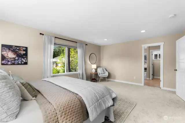 A spacious primary retreat includes an ensuite full bathroom and a walk in closet.