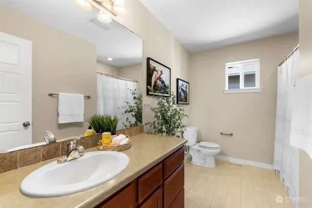 The full shared guest bath is located steps from the bedrooms for convenience.