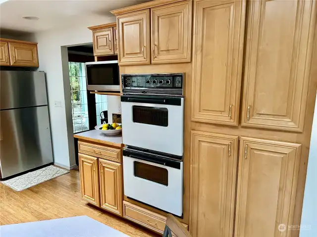 This shows the double oven and wall of pantry cabinets.