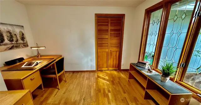 The den/4th bedroom is located just off the entry with wood floors and another set of the beautiful wood wrapped windows with lead and beveled glass.