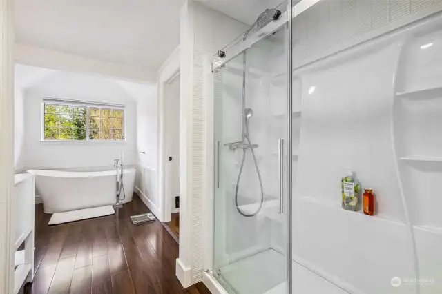 Large walk-in shower and elegant, free-standing bathtub with floor mounted tub filler.