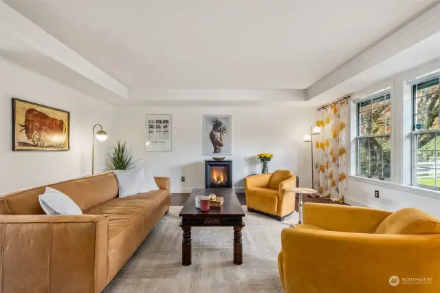 The sunlit living room is accented with a lovely cove ceiling and elegant Enviro S201 free-standing, propane fireplace installed in 2021. Propane tank is owned and not leased.