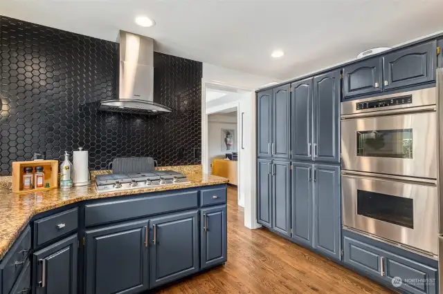 Bold and elegant, this spacious kitchen enjoys an abundance of cabinetry, stainless steel appliances and new Electrolux gas range.