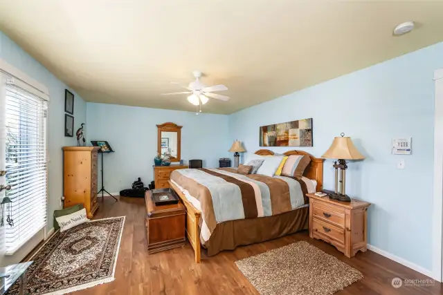 This spacious primary bedroom has a ceiling fan and a walk in closet. This window has an amazing view of Puget Sound. Soft colors to lull you asleep.
