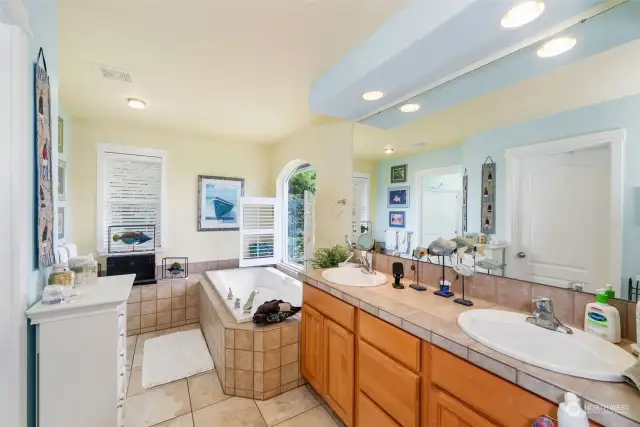 The primary bath has a double vanity and la ovely soaking tub and, yes, of course there's the view!