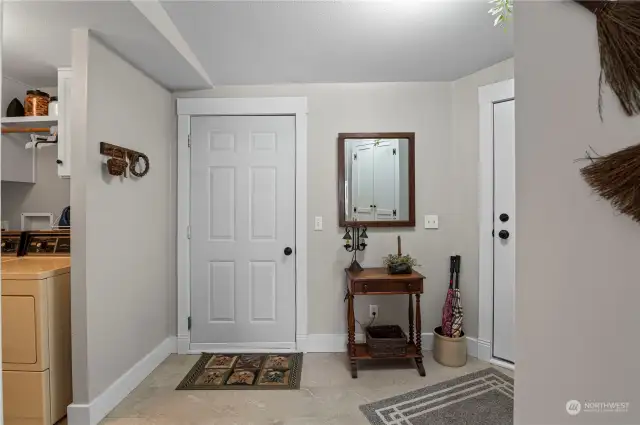 Mud room with back entry door and door to garage and laundry room