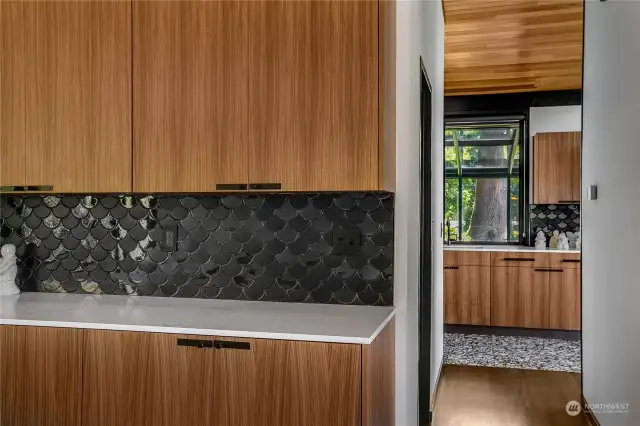From the sleek lines of walnut cabinetry to the intricate patterns of terrazzo tile, every element speaks to the meticulous craftsmanship that defines this residence.