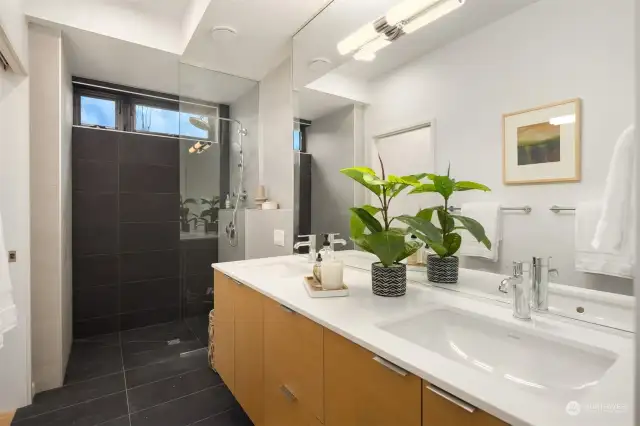 The main floor ensuite is thoughtfully designed with age-in-place features, such as a curbless shower, ensuring accessibility and convenience for all ages.