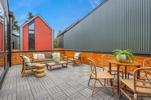 The expansive roof deck is a wonderful space for relaxing, dining, and enjoying panoramic views of the surrounding area, making it an ideal spot for entertaining or unwinding in the open air.