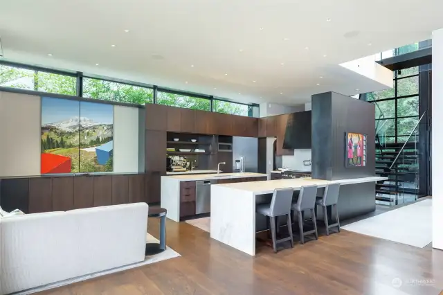 Fully appointed, world class kitchen with adjacent sitting nook. Flat screen TV hidden behind sliding art panels.