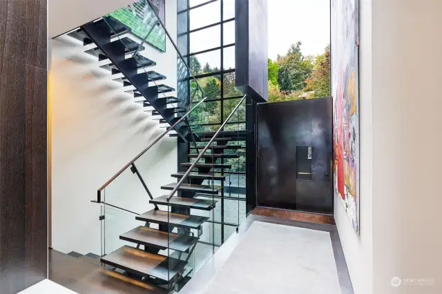 Dramatic main entry; steel, glass and oak staircase, twenty two foot ceilings, double Dutch door, walls for art.