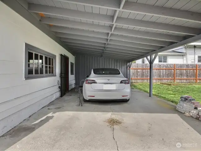 The oversized carport  can be used for parking or outdoor covered entertaining!