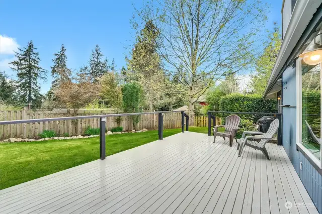 The deck faces south, capturing great sun, overlooking an immaculate back yard.