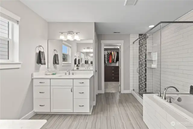 The primary bath also features a large step-in shower and a walk-in closet.