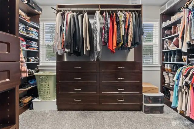 The primary walk-in closet features lots of built-ins and windows!