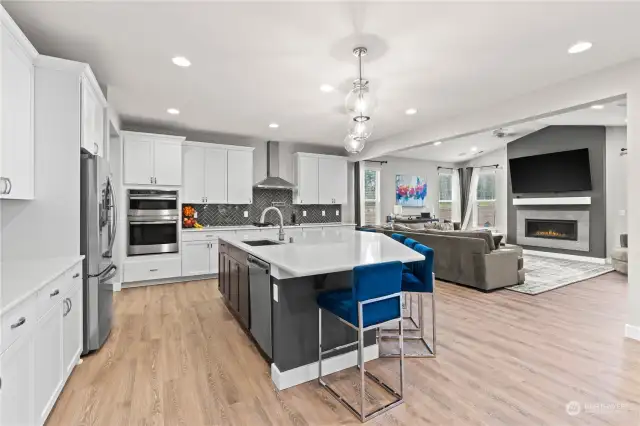 Stainless appliances, full height backsplash, and an expansive dream island with eating bar adds to the appeal of this kitchen.