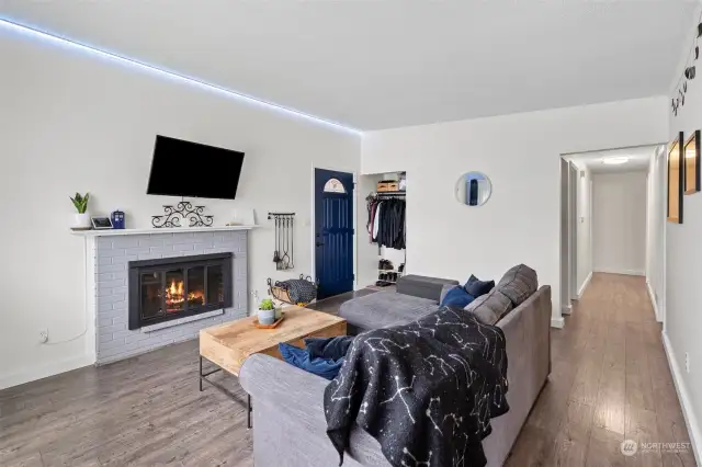 Main entry into Living Room - cozy gas fireplace.