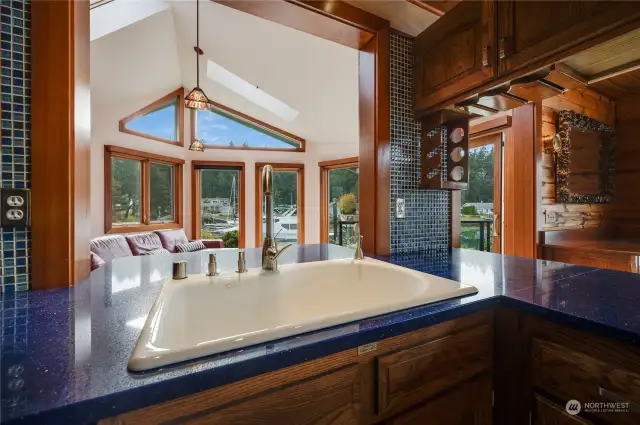 Extra large custom porcelain kitchen sink with instahot water tap. The counter behind the sink extends into the family room. Doing dishes with a view of your boat at your dock. It is a dream come true!